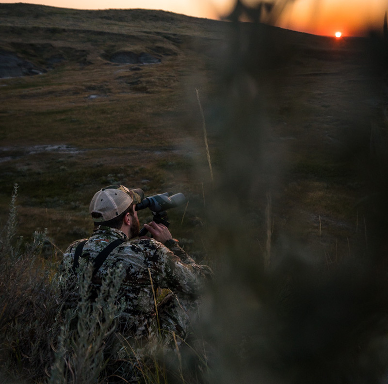 Hunter glassing with a spotting scope.